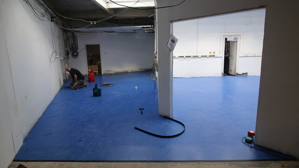 The new floor tiles, looking from the main space across the craft area towards the toilets and kitchen.