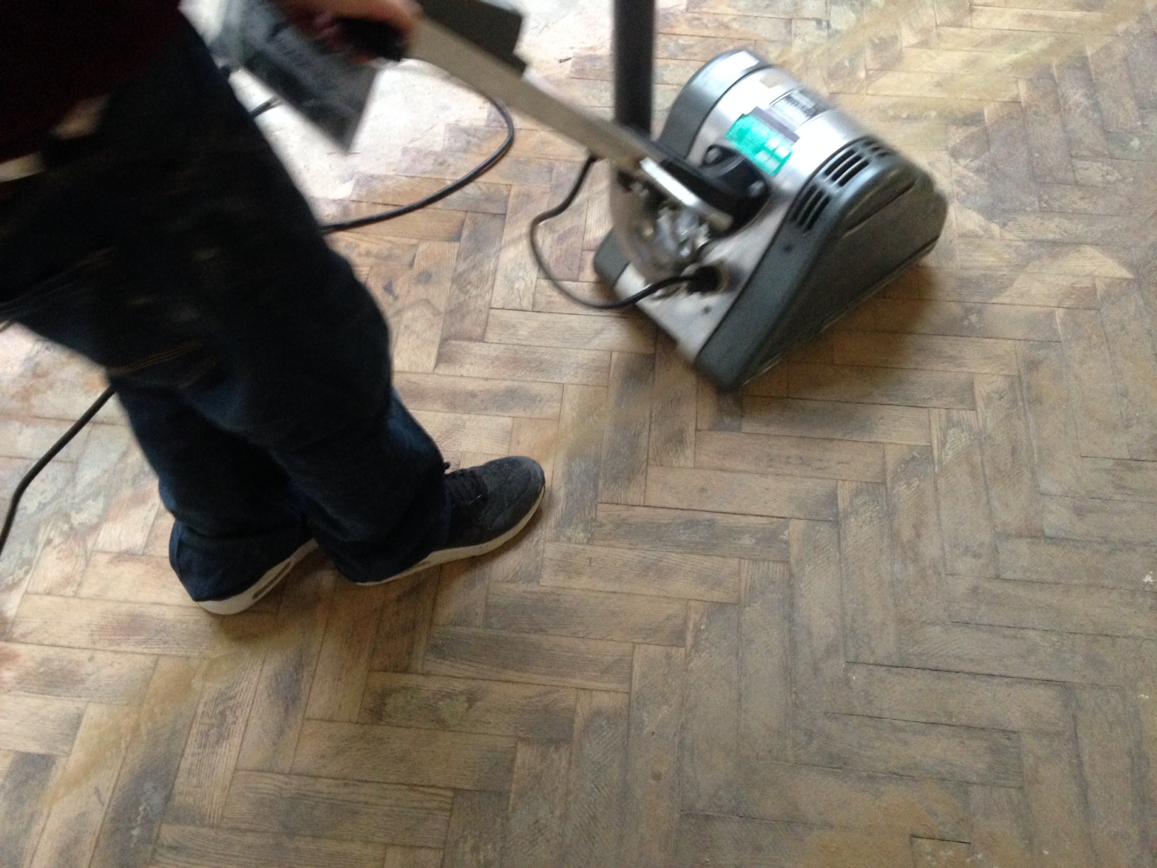 Sanding the floor with an electric floor sander