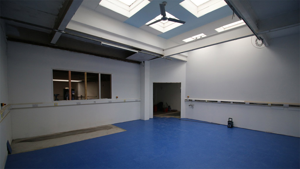 Blue workshop floor, with blue roof and ceiling fan